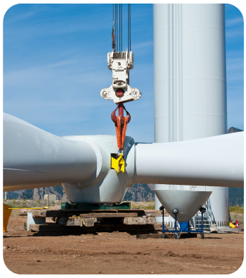 A giant wind turbine is undergoing maintenance