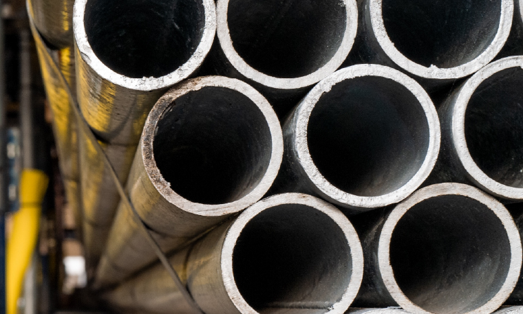 Industrial metallic tubes in a stack.